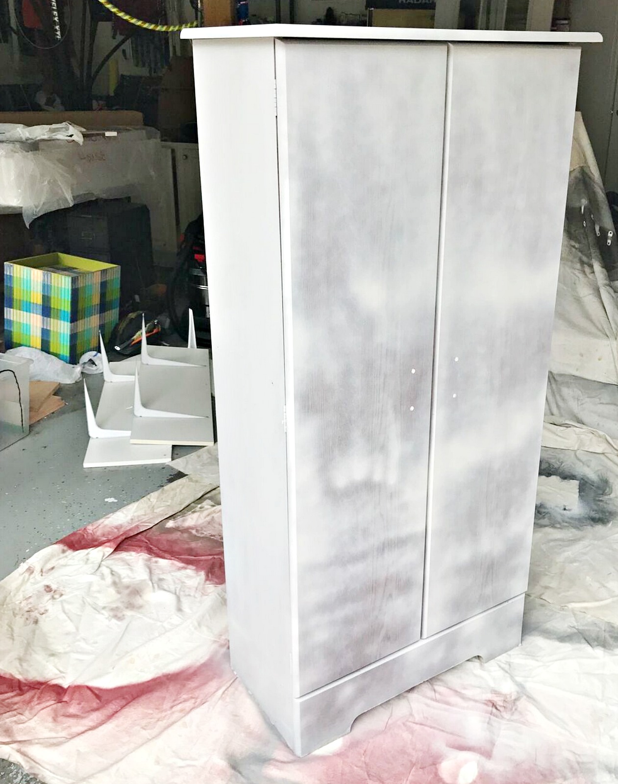 spray painting a laminate cabinet with chalked paint