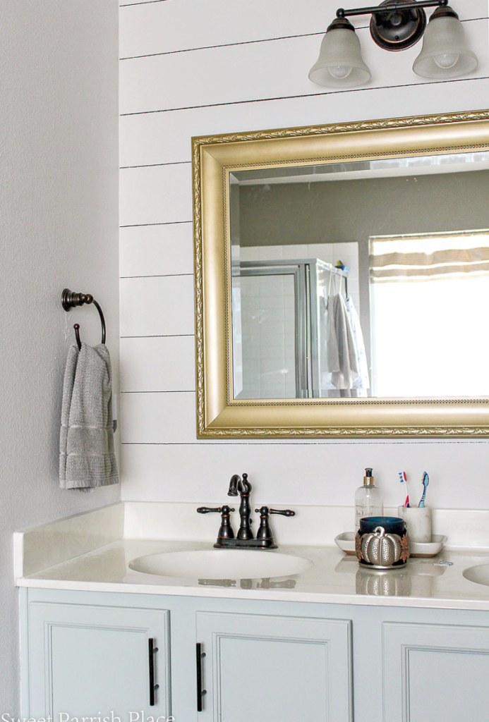 Sharpie Shiplap on Textured Walls with seal salt cabinets and gold mirror