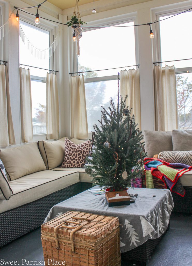 cozy and casual Christmas  sunroom with small real tree