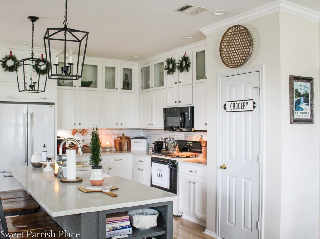 cozy and casual Christmas kitchen- white kitchen wth Christmas greenery