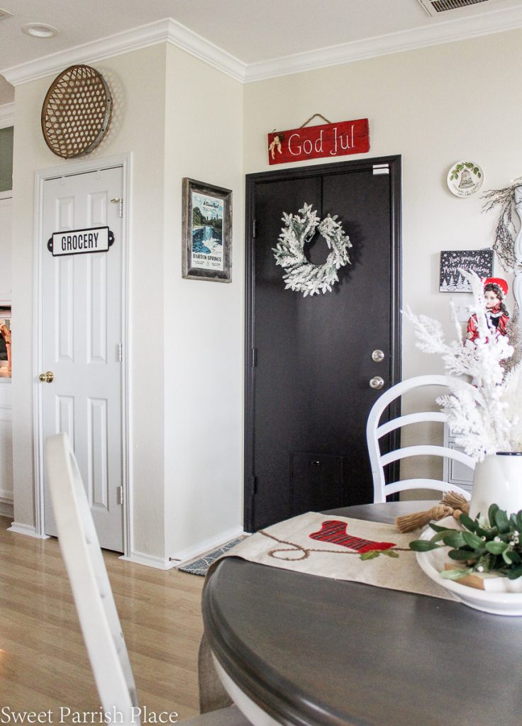 black door with flocked wreath and God Jul sign